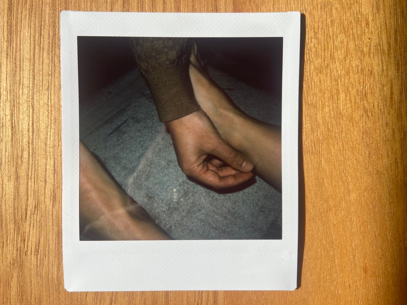 Hands resting on a patient's arm during treatment