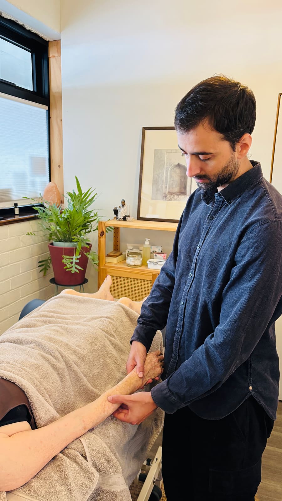 Lou taking a pulse at the treatment table